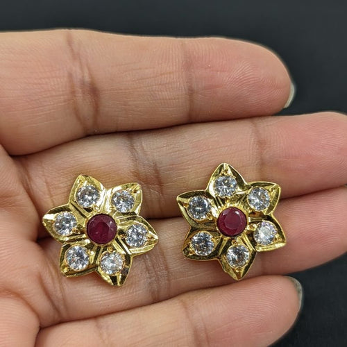 Tara Jadau Stud Earrings with real ruby stone shown in hand