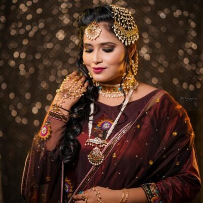 Close-up of Navratan choker, 22-carat gold plated jewelry, intricate design details on bridal set.