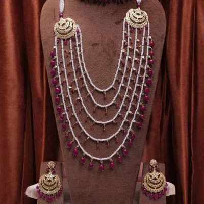 Close-up of Muskan Bridal Set chandbali featuring intricate gold work and ruby details.